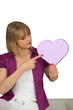 Woman pointing to a heart-shaped box