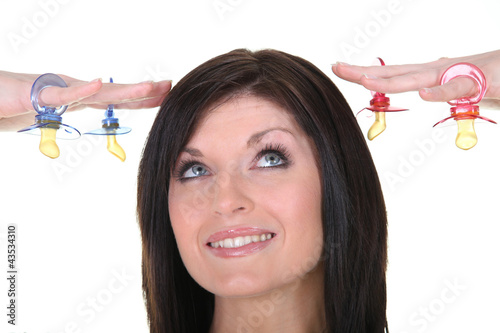 Photo: Brunette holding dummies Brunette holding dummies