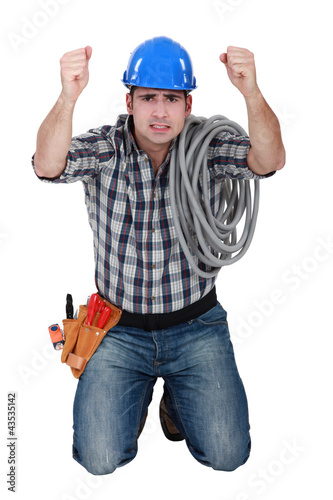 Photo: Workers on knees with fists raised Workers on knees with fists raised