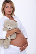 Pregnant woman with teddy bear