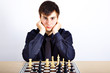 Young business man playing chess