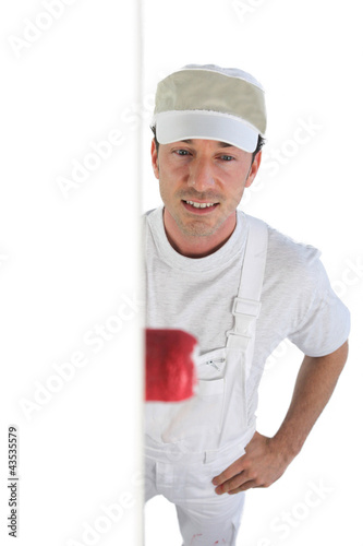 Photo: Man painting a wall Man painting a wall