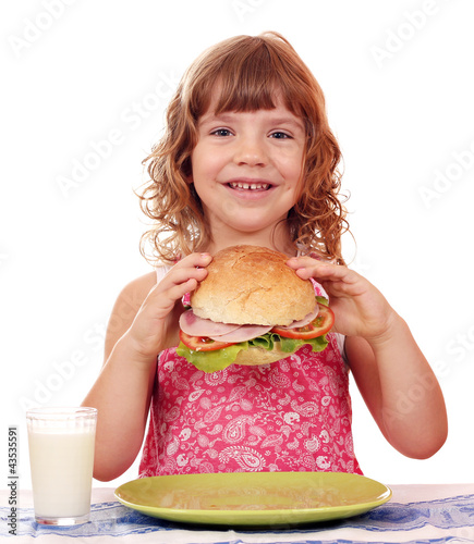 Photo: happy little girl with big sandwich happy little girl with big sandwich