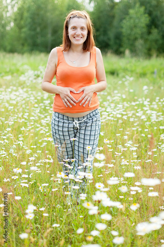Photo: pregnant woman at camomile plant pregnant woman at camomile plant