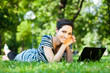 Beautiful young woman  using her laptop outdoors