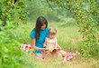 Photo: mother and daughter reading book together outdoor mother and daughter reading book together outdoor
