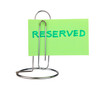 Photo: Mini stand with slip of paper and notice "Resereved". Isolated Mini stand with slip of paper and notice "Resereved". Isolated