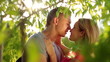 Video: View through the trees of loving couple kissing View through the trees of loving couple kissing