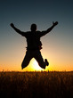 Young man jumping high in the air on sunny summer day