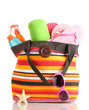 Beach bag with beach accessories, isolated on white