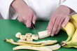 Foto: female chef cutting a banana female chef cutting a banana