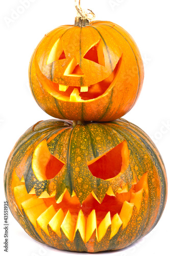 Photo: Halloween pumpkins with scary face over white background Halloween pumpkins with scary face over white background
