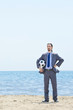Businessman with football on beach
