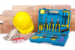 Construction concept with helmet and toolkit