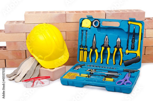 Foto: Construction concept with helmet and toolkit Construction concept with helmet and toolkit