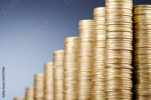 Photo: Golden coins in high stacks Golden coins in high stacks