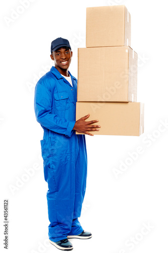 Photo: Young delivery boy holding cardboard boxes Young delivery boy holding cardboard boxes