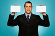 Businessman showing two blank white placards