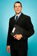 Corporate man holding clipboard and posing