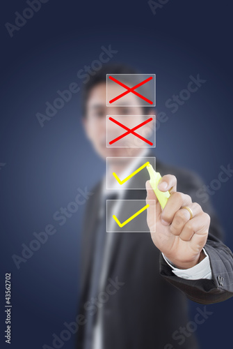 Photo: Businessman writing correct choice. Businessman writing correct choice.