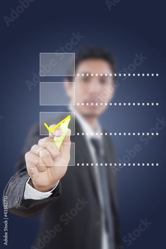 Photo: Businessman writing correct choice. Businessman writing correct choice.