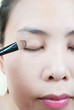 Close up Asian young woman make up.