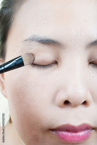 Photo: Close up Asian young woman make up. Close up Asian young woman make up.