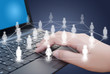 Hand pushing laptop keyboard with Social Network.