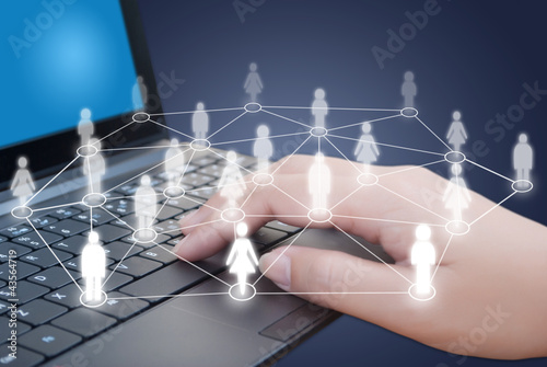 Photo: Hand pushing laptop keyboard with Social Network. Hand pushing laptop keyboard with Social Network.
