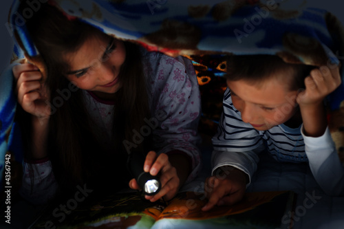 Photo: Children reading at night Children reading at night