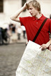 A lost guy holding a map looking for directions