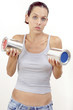 A woman in jeans holding a tin of red paint and blue paint