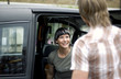 A woman sitting in a van waiting for her boyfriend to get in