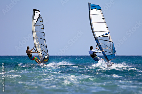 Photo: Two windsurfers in action Two windsurfers in action
