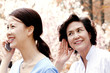 An old woman trying to listen to her daughter's phone conversation 
