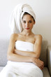 Woman in towel sitting on the couch 
