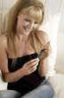 Woman sitting on the bed looking at her boyfriend's picture 