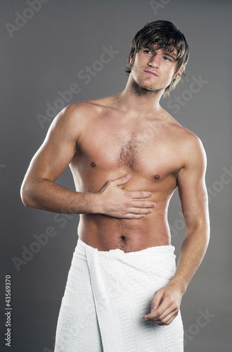 Photo: Muscular man wrapped in towel Muscular man wrapped in towel