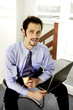 Businessman with his tie being dipped into a cup of coffee