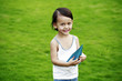 Little girl holding a paper plane