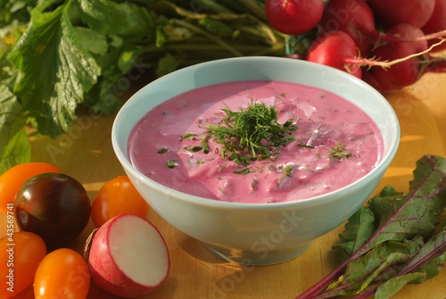 Photo: Chłodnik - cold beetroot soup in a bowl on a wooden table Chłodnik - cold beetroot soup in a bowl on a wooden table