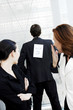 Businessman with a kick me sign on his back