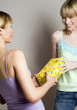 Woman receiving present from her friend