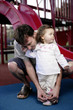 Father tying shoelace for her daughter