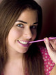 Woman biting a drinking straw