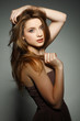A beautiful young woman is in brown clothes