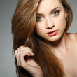 A beautiful young woman is in brown clothes