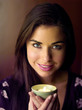Woman holding a lighted aromatherapy candle