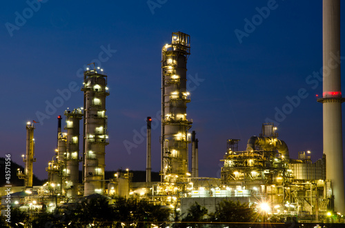 Photo: Petrochemical industry on sunset dark blue sky. Petrochemical industry on sunset dark blue sky.