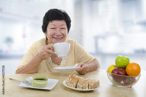 Photo: Senior woman having breakfast Senior woman having breakfast